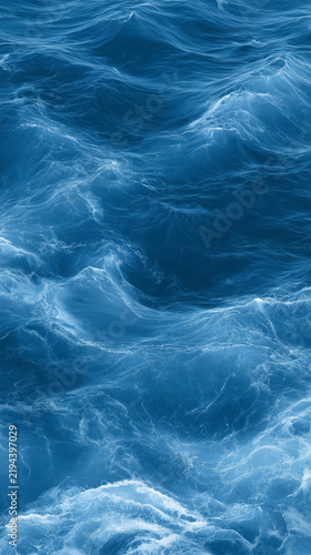 Deep blue ocean surface rolling in choppy waves with white foam crests. Natural sea texture. Ideal for travel, marine and refreshing backgrounds.