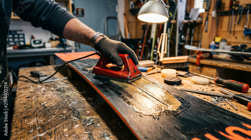 Crafting a snowboard at a workshop during the day