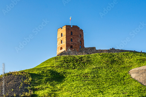 Gediminas tower and upper castle ruins on hill in Vilnius Lithuania under blue sky