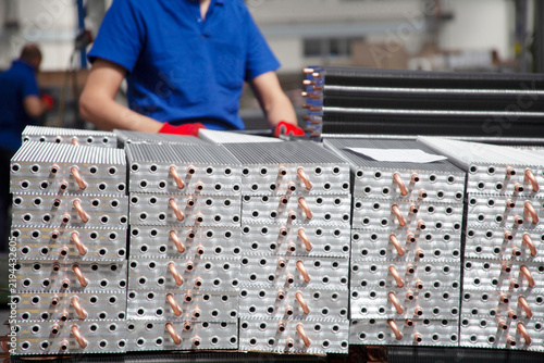 These are copper-tube, aluminum-fin coils (condenser or evaporator blocks) used in refrigeration and air conditioning systems.
