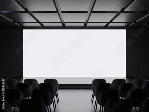 Empty conference room with large blank LED screen and rows of chairs
