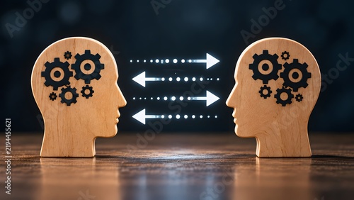 Wooden head silhouettes facing each other with internal mechanical gears and bidirectional arrows representing two-way communication knowledge transfer and collaborative thinking