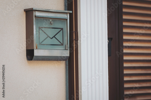 Mailbox quietly waiting for letters to arrive outside a cozy home