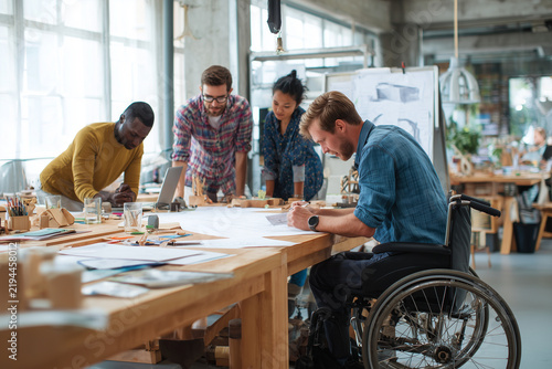 Inclusive Team Of Industrial Designers Collaborating In Bright Accessible Studio