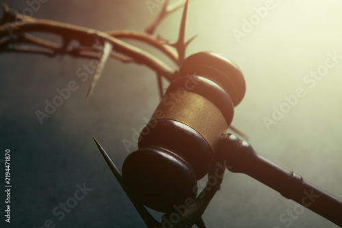 Quadro su tela Barbed wire crown of thorns and judge gavel on dark background