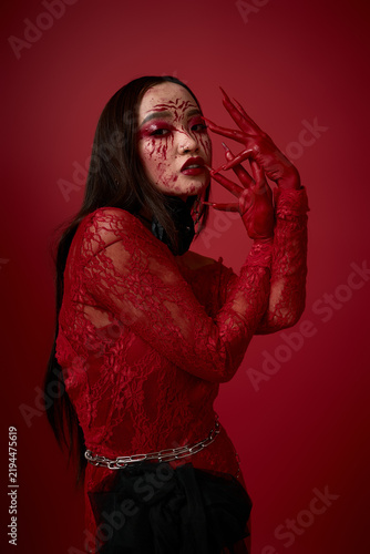 Creepy Halloween look with a young Asian woman in bold red makeup