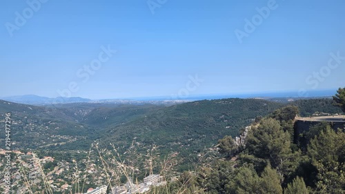 Beautiful Scenic View from a Mountain Overlooking a Valley and Blue Sky. A tranquil panorama filled with greenery. Perfect for nature lovers and travelers.