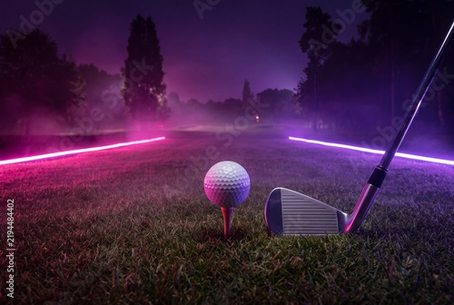 Striking night golf scene, ball on tee and club, illuminated by neon pink lights