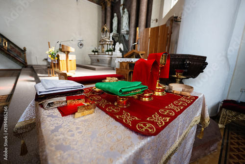 фотографія Altar with chalice, paten and folded vestments on red altar cloth ready for Cath