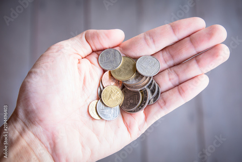hand with coin baht isolated background