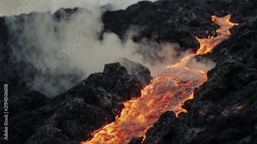 Molten lava flowing down a volcanic slope with steam and smoke during daytime cinematic motion