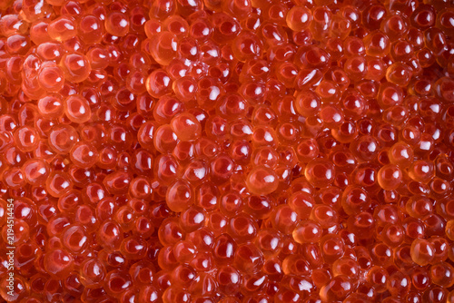 Bild auf Leinwand Close-Up of Fresh Salmon Caviar (Ikura) with Vibrant Orange Pearls and Glossy Te