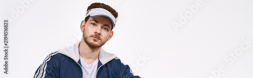 Obraz na płótnie Sporty young man radiates confidence in stylish athletic wear