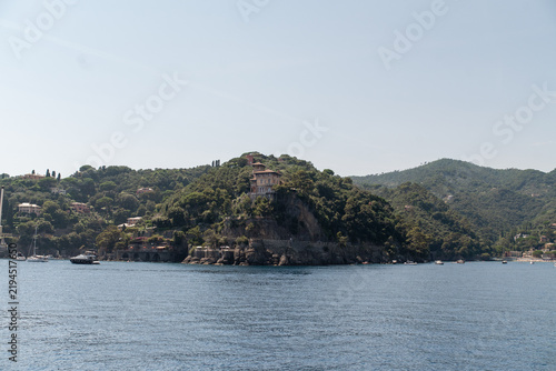 Obraz na płótnie Scenic coastal landscape of Portofino, Liguria, Italy, with lush green hills, Mediterranean villas and calm blue sea on a sunny summer day