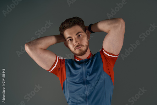Fotografie Sporty young man striking a confident pose in a stylish athletic outfit
