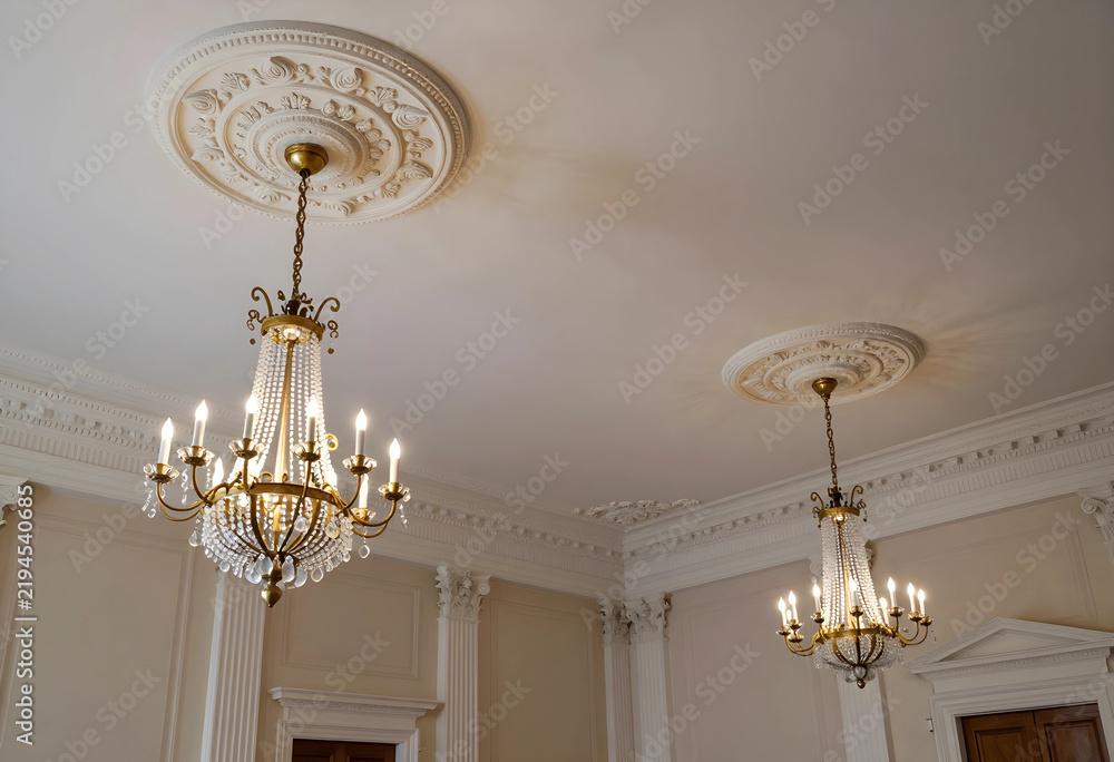 Obraz premium Luxury interior design and classic architecture, elegant crystal chandeliers hanging from ornate ceiling medallions in a historic mansion ballroom