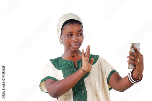 Smiling African woman waving in front of her phone screen