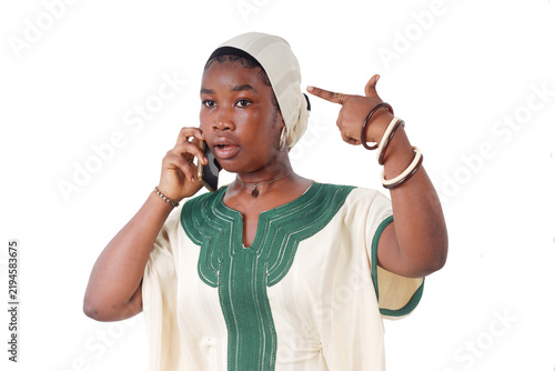 Confused African woman on the phone, pointing her finger at her head