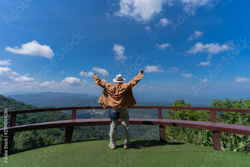 Canvastavla A tourist stands at a mountain viewpoint, gazing at the skyline scenery at Mon Jam, Chiang Mai, Thailand