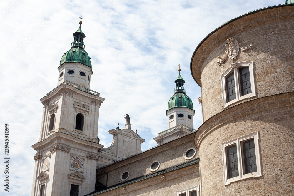 Fototapeta premium Green Copper Dome and Apse of Salzburg Cathedral against Blue Sky with Clouds in Salzburg, Austria.