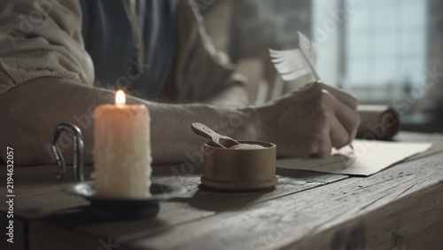 Bild auf Leinwand Small wooden pounce pot with a scoop on a table with hands of a medieval master