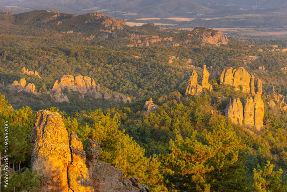 Obraz premium Belogradchik Rocks in Bulgaria, a spectacular natural rock formation featuring towering red sandstone and conglomerate cliffs shaped by erosion. The dramatic rock landscape