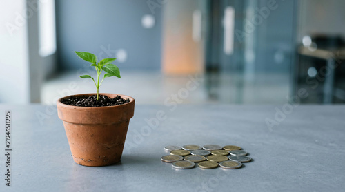 Business success concept with Healthy green seedling in a simple clay pot beside a compact group of coins, minimalist business still life, with generous copy space