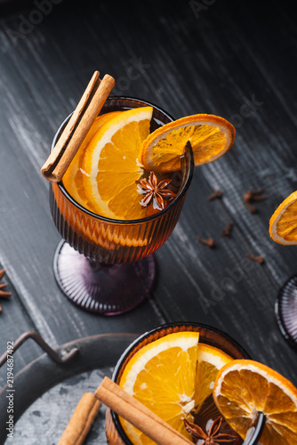 Konstfotografi White mulled wine with orange cinnamon and star anise on dark wood autumn warmin