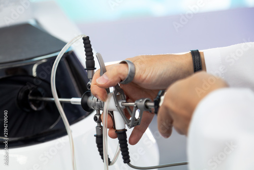 Selective focus on a hysteroscope in hands of male doctor