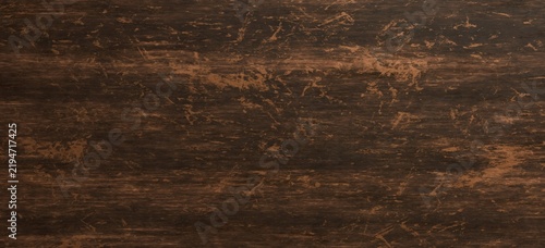 Rustic dark brown wood grain texture background with weathered distressed pattern and worn surface details