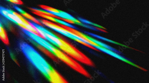 Abstract rainbow light rays glowing on a dark background