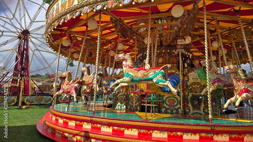 Colorful Vintage Carousel With Painted Horses At Outdoor Fairground During Festival