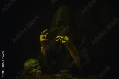 Mysterious hooded cultist with playing cards