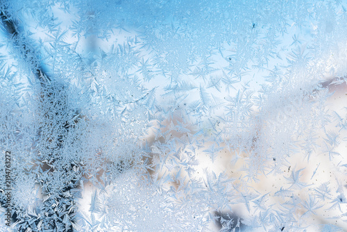 Close up view of  frost crystals on window glass at sunny day