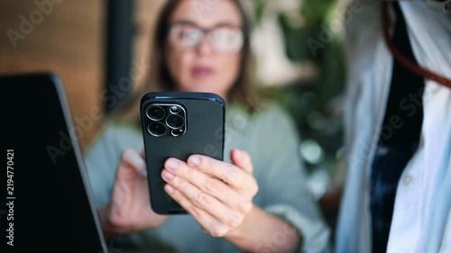 Professional Woman Using Smartphone In Modern Coworking Space During Casual Office Break