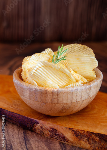 Crunchy potato chip  over savory snack bowl