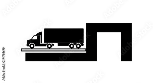 Black silhouette icon of a semi truck trailer at a loading dock isolated on a white background