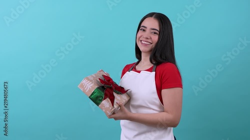 Store clerk wrapping and holding a christmas gift