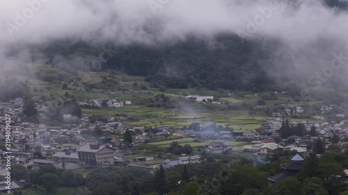 Smoke, low cloud, and fog over small village in rural mountains of Nagano Prefecture, Japan
