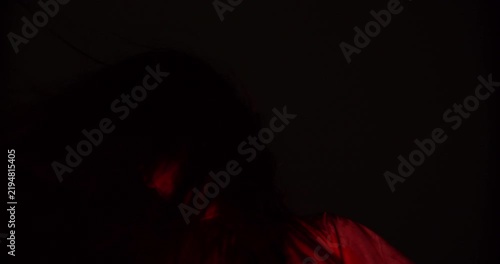 A terrifying demonic figure with one glowing eye emerges from pitch-black darkness, embodying a nightmarish and evil supernatural presence for a disturbing horror concept.