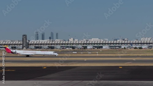 Commercial Airplane Taxiing Across Madrid Airport Runway Area