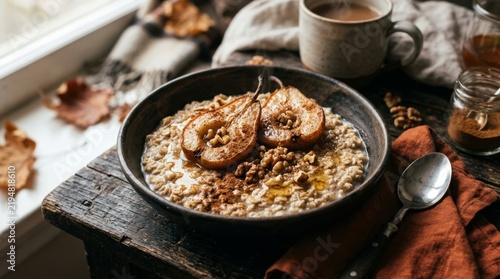 Rustic oatmeal topped with caramelized fruit and nuts on wooden surface near autumn leaves with food