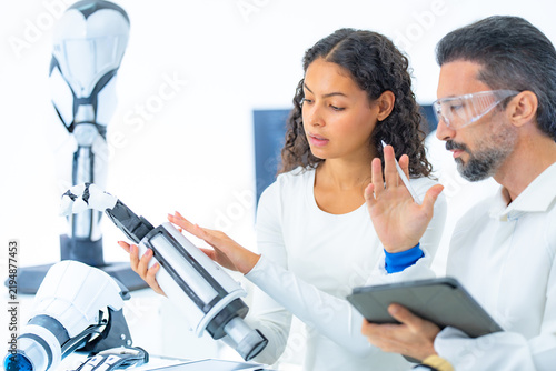 Картината върху платно Physical AI research demonstration where a scientist raises her open palm beside