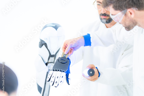 Фотография Collaborative robotics testing: a researcher fingertip meets the black mechanica