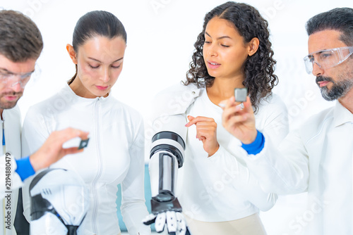 Konstfotografi Haptic feedback engineering with a scientist studying a white tactile sensor blo
