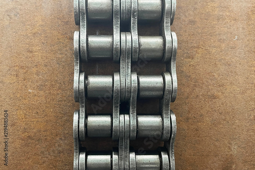 Принти на полотні Heavy roller chain on brown metal surface background