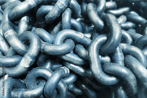 фотографія Heavy metal chains piled together in industrial background