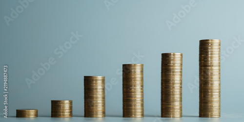 Gold coin stacks arranged in increasing order for financial growth and investment concept