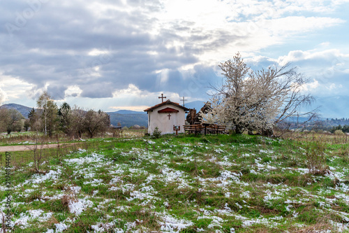 Small chapel in a rural snowy landscape, Bulgaria.