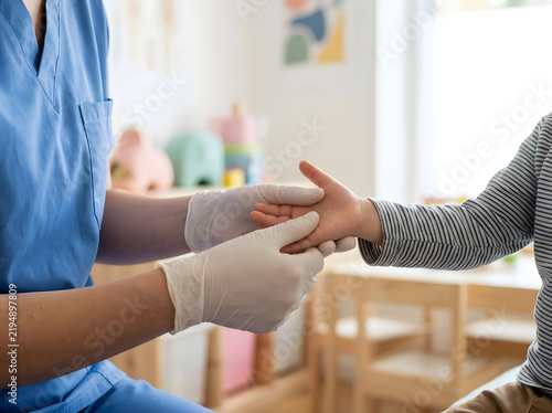 Doctor examining a child s hand in a brightly lit medical office